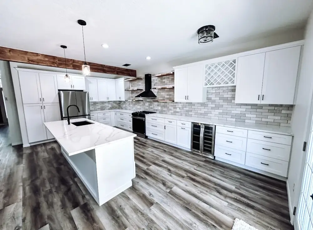 Matte-black range hood and gas range centered between floating wood shelves on a glossy subway-tile wall